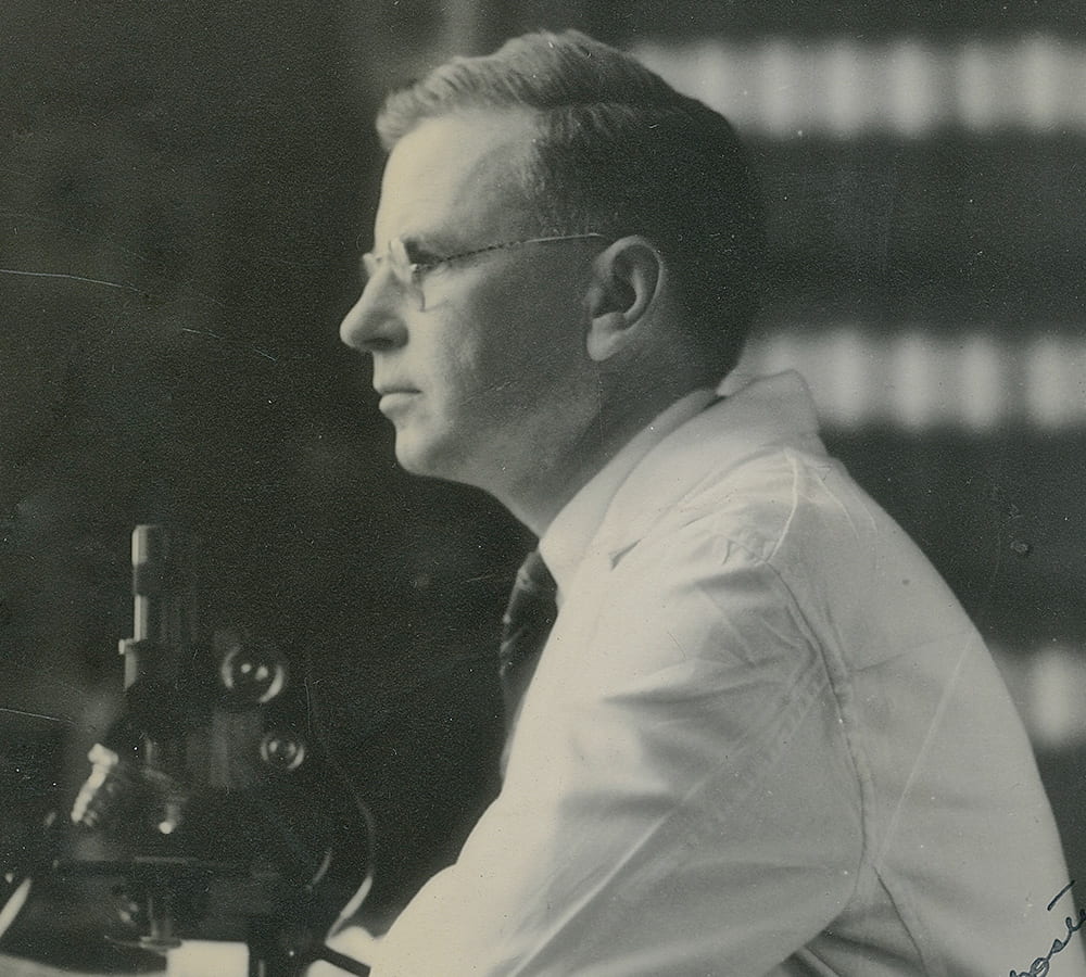 Ernest Goodpasture working with a microscope