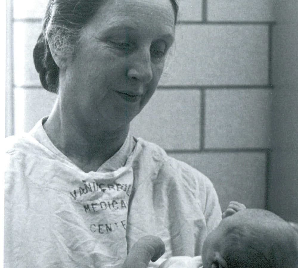 Mildred Stahlman holding a baby