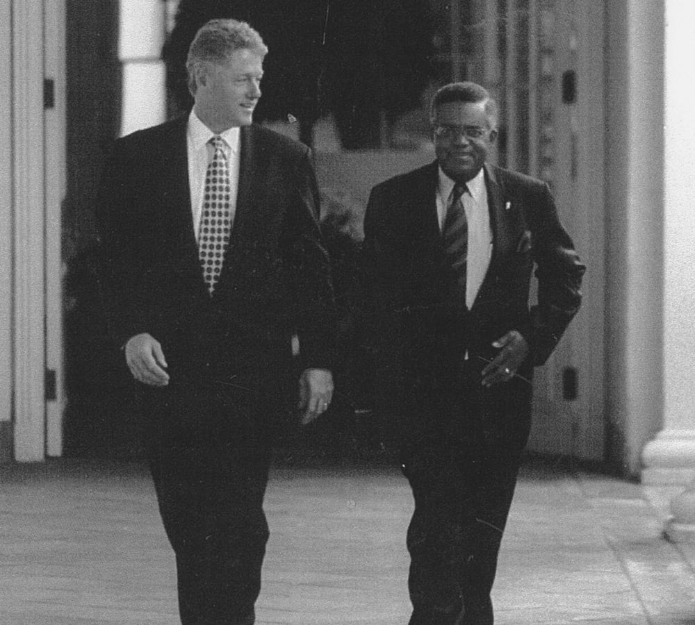Henry Foster walking with President Bill Clinton