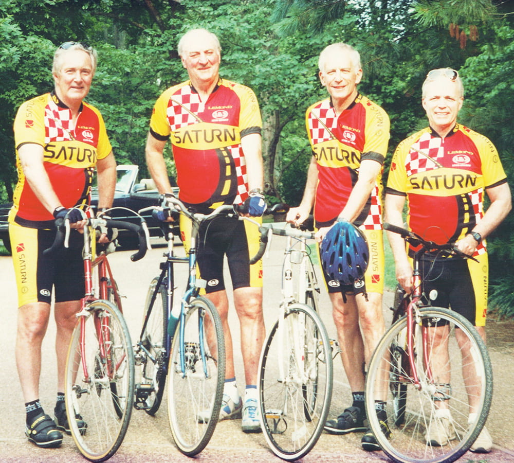 Joel Gordon posing with colleagues and their bicycles