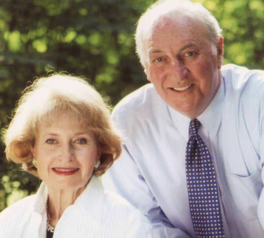 Joel Gordon posing in a photo with his wife
