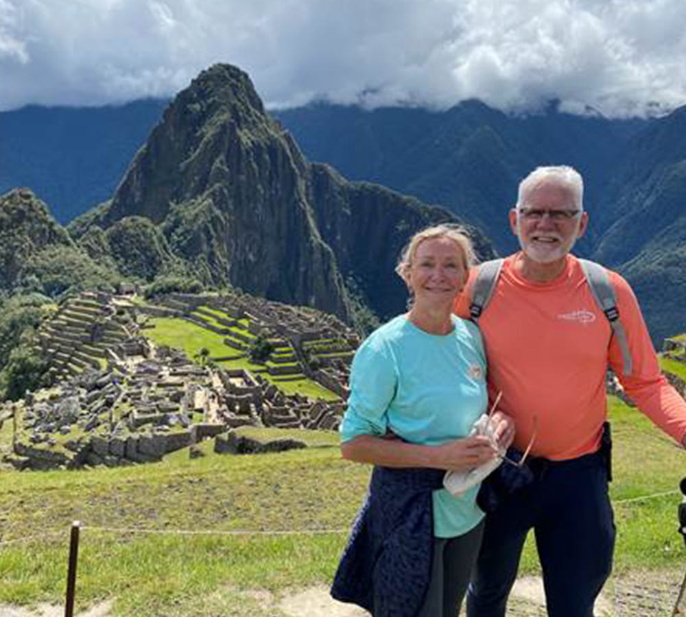 Dr. Wykoff and his wife posing with Machu Picchu in the distance